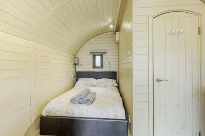 a small bed in a small room with an archway at Stiperstones Pod in Shrewsbury