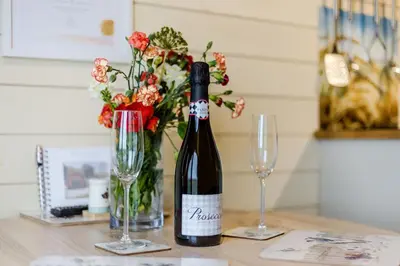 a bottle of wine and two glasses on a table at Corndon Pod in Shrewsbury