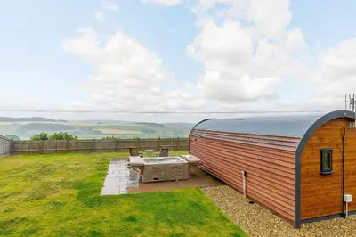 a trailer sitting on top of a grass field at Corndon Pod in Shrewsbury