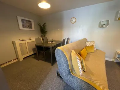 a living room with a couch and a table at Westend Holiday Let 2 Brecon in Brecon