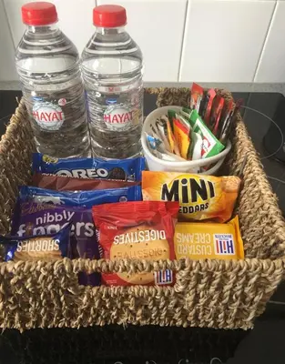 a basket with two bottles of water and snacks at Westend Holiday Let 2 Brecon in Brecon