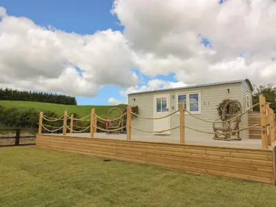 a house with a wooden fence around it at Marches Way in Rhayader