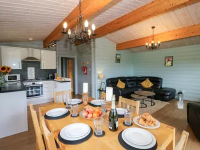 a dining room and kitchen with a table and chairs at Sunny View in Rhayader