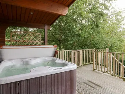 a hot tub on the deck of a house at Sunny View in Rhayader