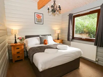 a bedroom with two beds and a window at Sunny View in Rhayader