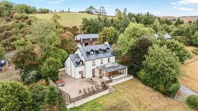 an aerial view of a large white house at Barn Owl Lodge in Rhayader