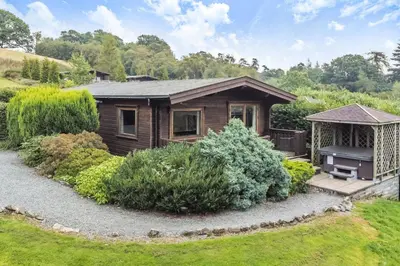a small house with a gazebo in a yard at Hillside View in Rhayader