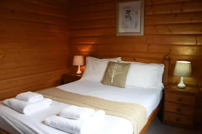 a bedroom with a bed with towels on it at Hillside View in Rhayader