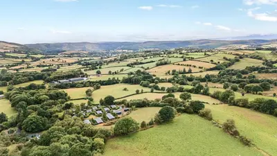 an aerial view of a village in the hills at Hillside View in Rhayader
