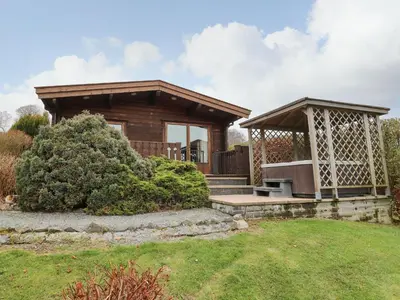 a small wooden cabin with a gazebo at Valley View in Rhayader