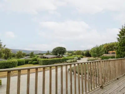 a wooden balcony with a fence and a walkway at Mountain View in Rhayader