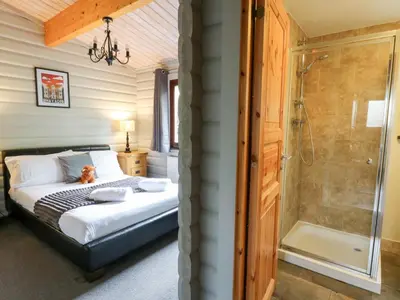 a bedroom with a bed and a shower at Mountain View in Rhayader