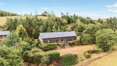 an aerial view of a house in a field at Snowy Owl Lodge in Rhayader