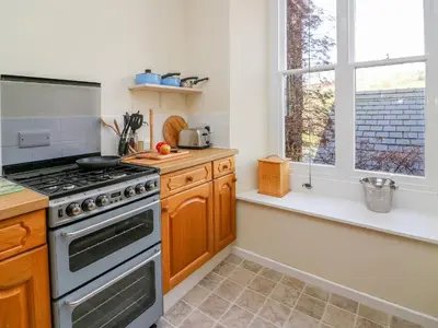 a kitchen with a stove and a window at Garden View in Kington