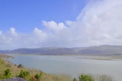 a large body of water with mountains in the background at 2 Bed in Aberdyfi oc-wah694 in Aberdyfi