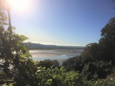 a view of a river with the sun in the sky at 2 Bed in Aberdyfi oc-wah694 in Aberdyfi
