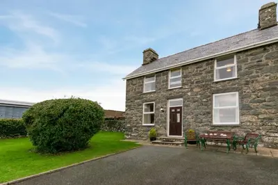 an old stone house with a picnic table in front of it at 2 Bed in Barmouth oc-wah698 in Talybont