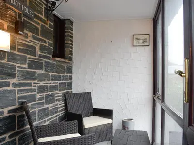 two chairs in a room with a brick wall at Hoot House in Abergynolwyn