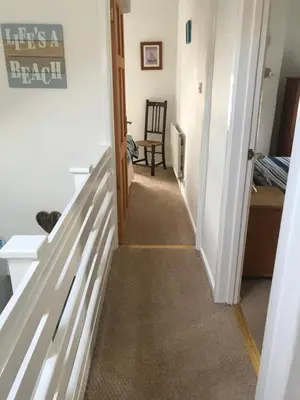 a hallway leading up to a room with a stairway at Aelfor Cozy Cottage in Barmouth