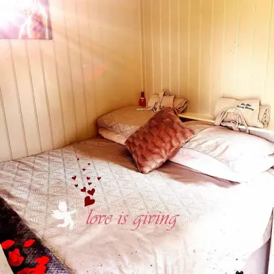 a small room with two beds in a corner at pen-rhos luxury glamping 