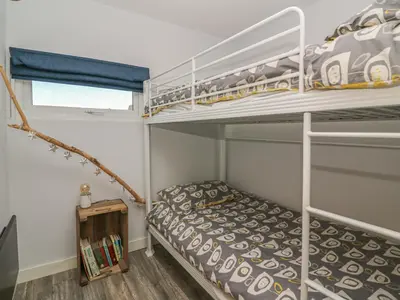 a small bedroom with a bunk bed and a bunk bed at Haka Lodge in Aberystwyth