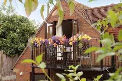 a balcony with a bunch of flowers on it at Oakland Cottage in Craven Arms