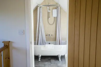 a bathroom with a bath tub and a sink at Finest Retreats - 1 Bed Llangollen Cottage - Sleeps 2 in Llangollen