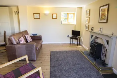 a living room with a couch and a fireplace at Finest Retreats - 1 Bed Llangollen Cottage - Sleeps 2 in Llangollen