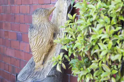 a statue of a bird perched on a tree branch at Finest Retreats - 1 Bed Llangollen Cottage - Sleeps 2 in Llangollen