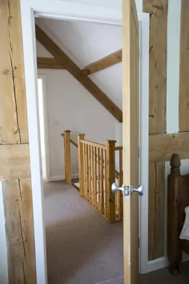 an open door to a room with wooden ceilings at Finest Retreats - 2 Bed Llangollen Cottage - Sleeps 4 in Llangollen