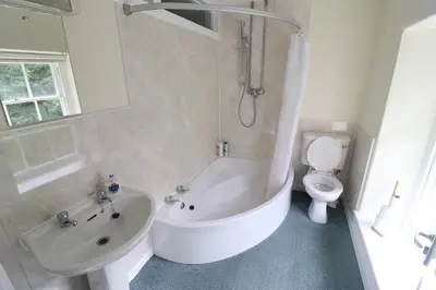 a bathroom with a tub and a sink and a toilet at Plas Dolau Country Estate in Aberystwyth