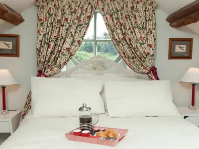 a bed with a tray of donuts on it at Rhydleos Mill in Llansilin