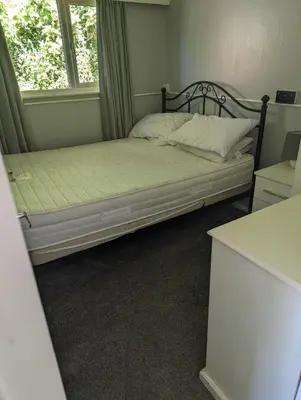 a bed sitting in a room with a window at Springside Chalet20 in Tywyn