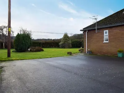 an empty street in front of a brick house at Kinverley in Evenjobb