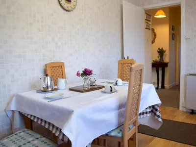 a table with a white table cloth and flowers on it at Kinverley in Evenjobb