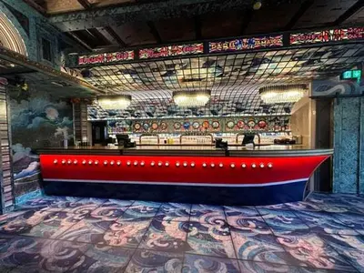 a stage with a red bench in a building at Chalet Kiss of the Sea in Aberystwyth