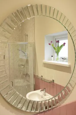a bathroom with a sink and a shower and a mirror at Cwmbach Lodge luxury B&B in Glasbury