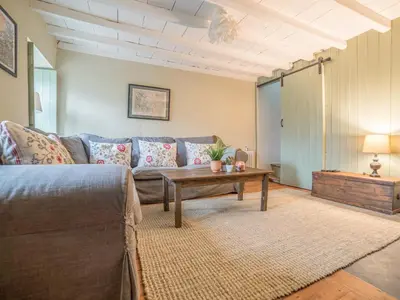 a living room with a couch and a coffee table at Bwthyn Dyfi in Machynlleth