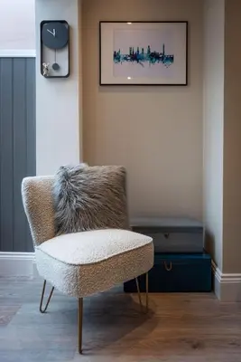a room with a chair and a picture on the wall at Cherry Orchard in Shrewsbury