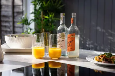 a table with two bottles and glasses of orange juice at Cherry Orchard in Shrewsbury