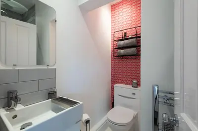 a small bathroom with a toilet and a sink at Cherry Orchard in Shrewsbury