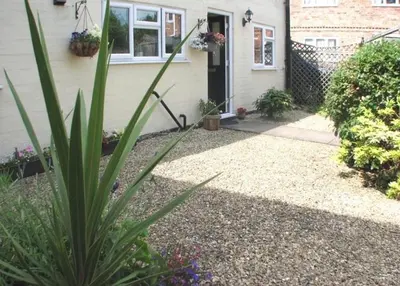 a house with a plant in front of it at 9 Bromleys Court in Church Stretton