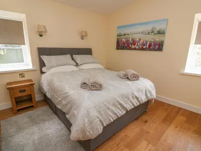 a bedroom with a bed with towels on it at Y Felin - Celyn in Borth