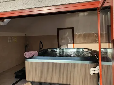 a jacuzzi tub in the corner of a room at Kestrel Farmhouse in Llandovery