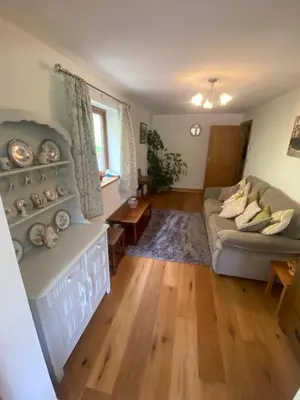 a living room with a couch and a table at Laurel Bank in Abbey-Cwmhir