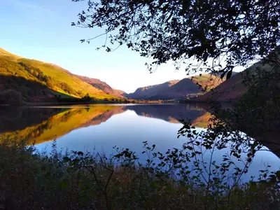 a view of a lake with mountains in the background at Pen-Y-Bont Hotel in Tal-y-llyn