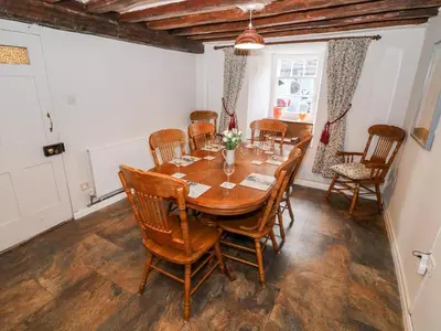 a dining room with a wooden table and chairs at Fro Awel in Dolgellau