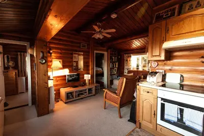 a kitchen with wooden walls and a ceiling at Rustic Log cabin in Snowdonia By Seren Short Stays in Trawsfynydd