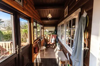 a hallway of a house with windows and a porch at Log Cabin nr Coed y brenin By Seren Short Stays in Trawsfynydd