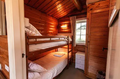 a bedroom with two bunk beds in a log cabin at Log Cabin nr Coed y brenin By Seren Short Stays in Trawsfynydd